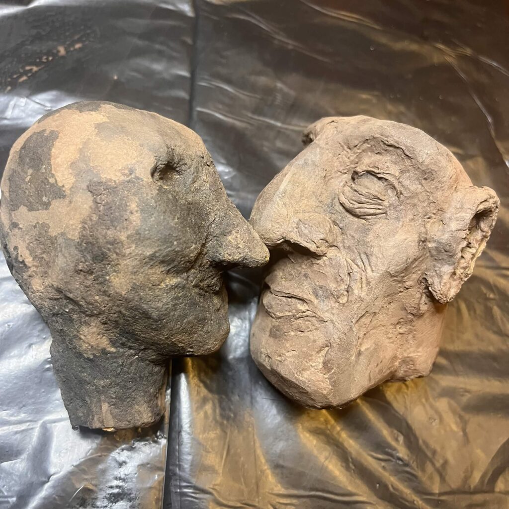 two freshly painted puppet heads
