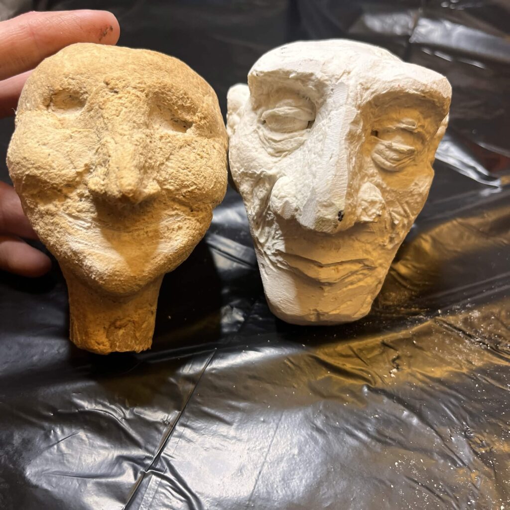 two puppet heads, a male and female