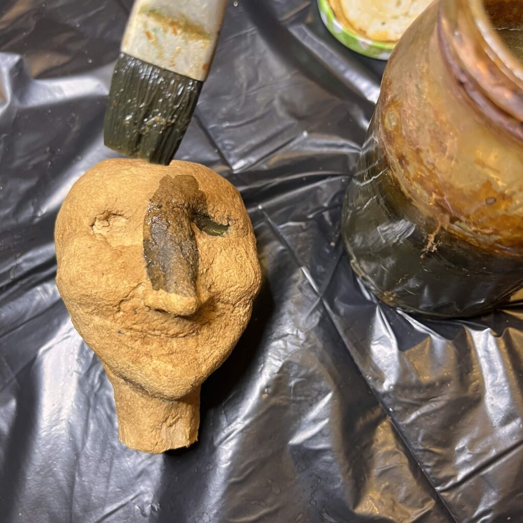 a puppet head in the process of being painted